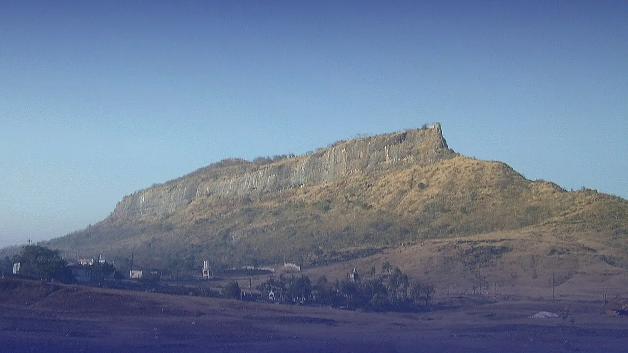 Shivneri fort on its hill, its skyline sketched over the photo.