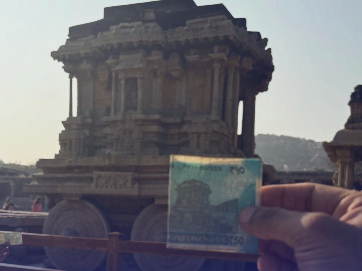 The Stone Chariot at Vittala, Hampi, with a 50 rupee note held up beside it. Chalk circles mark the chariot and the chariot printed on the note, joined by an arrow, with the words same chariot.